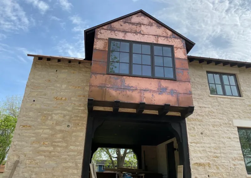 Copper metal panel facade on a stone building for Roof Repair in Pharr